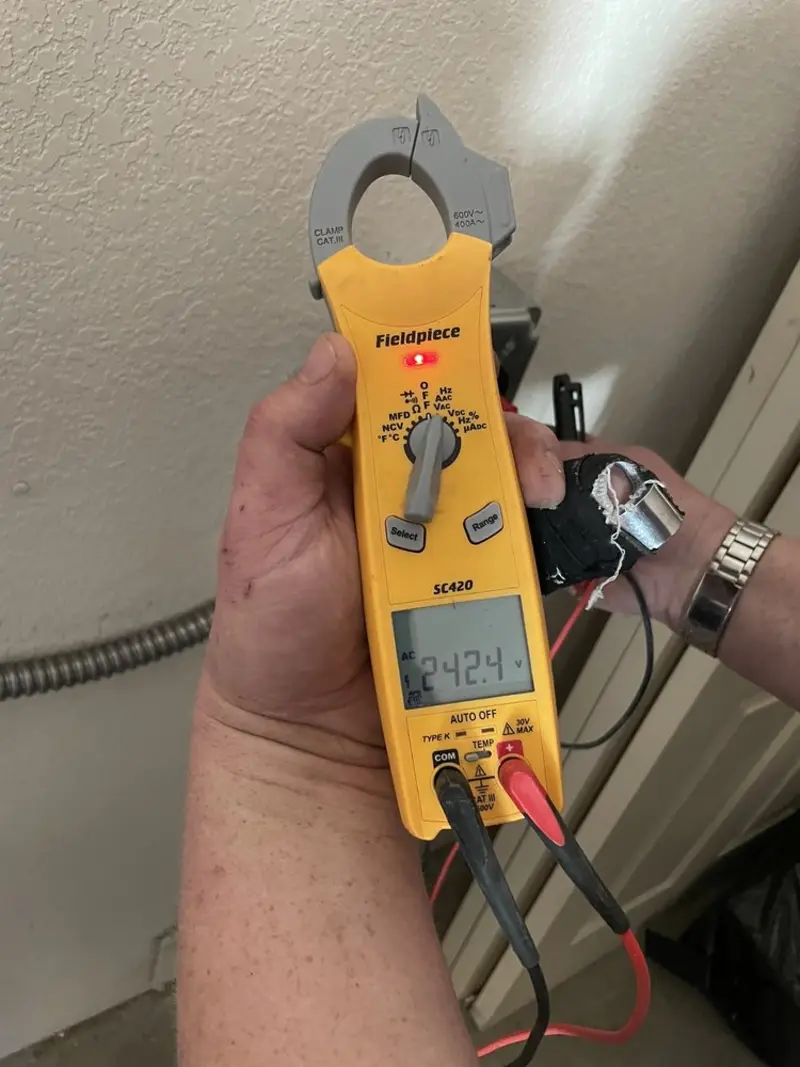 Voltage testing with clamp meter during Outlet Installation in Overland Park